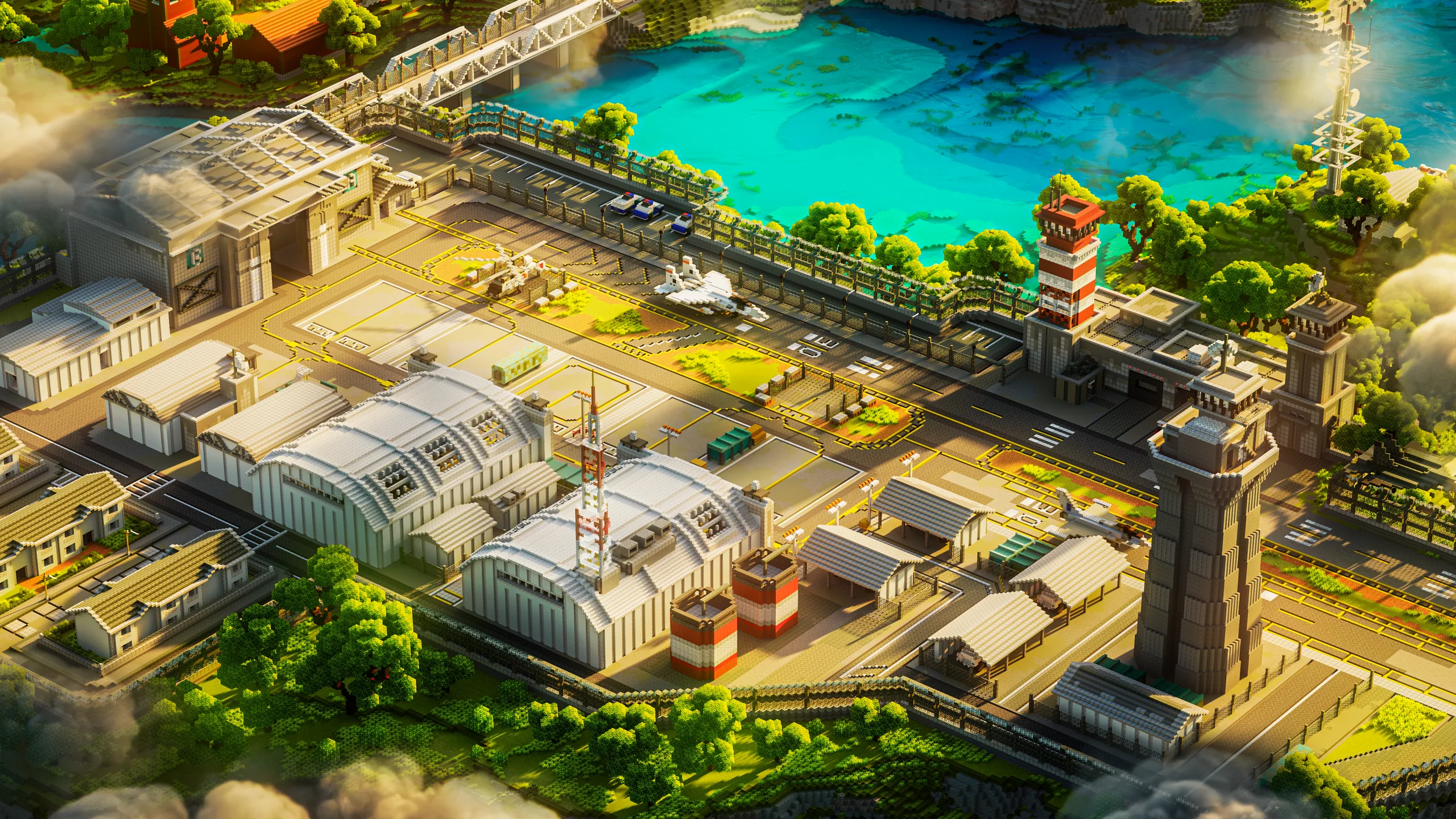 Minecraft aerial view of an airport complex with curved hangars, runways, control towers and service roads beside bright turquoise water and dense green trees.