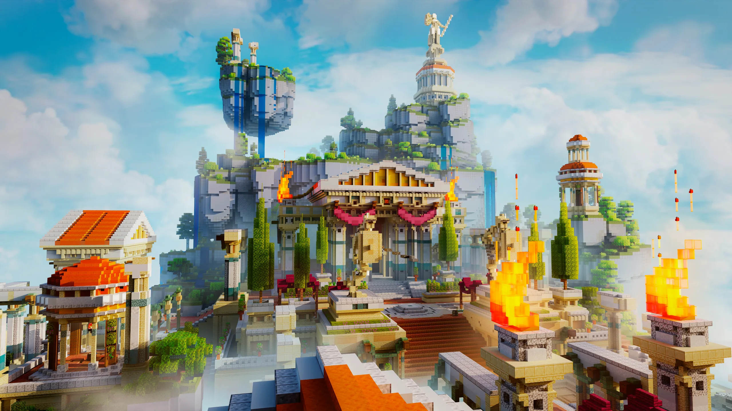 Minecraft build of a grand cliffside temple with pillars, towers, and statues above a stepped courtyard, framed by bright orange flames in the foreground and a blue sky.