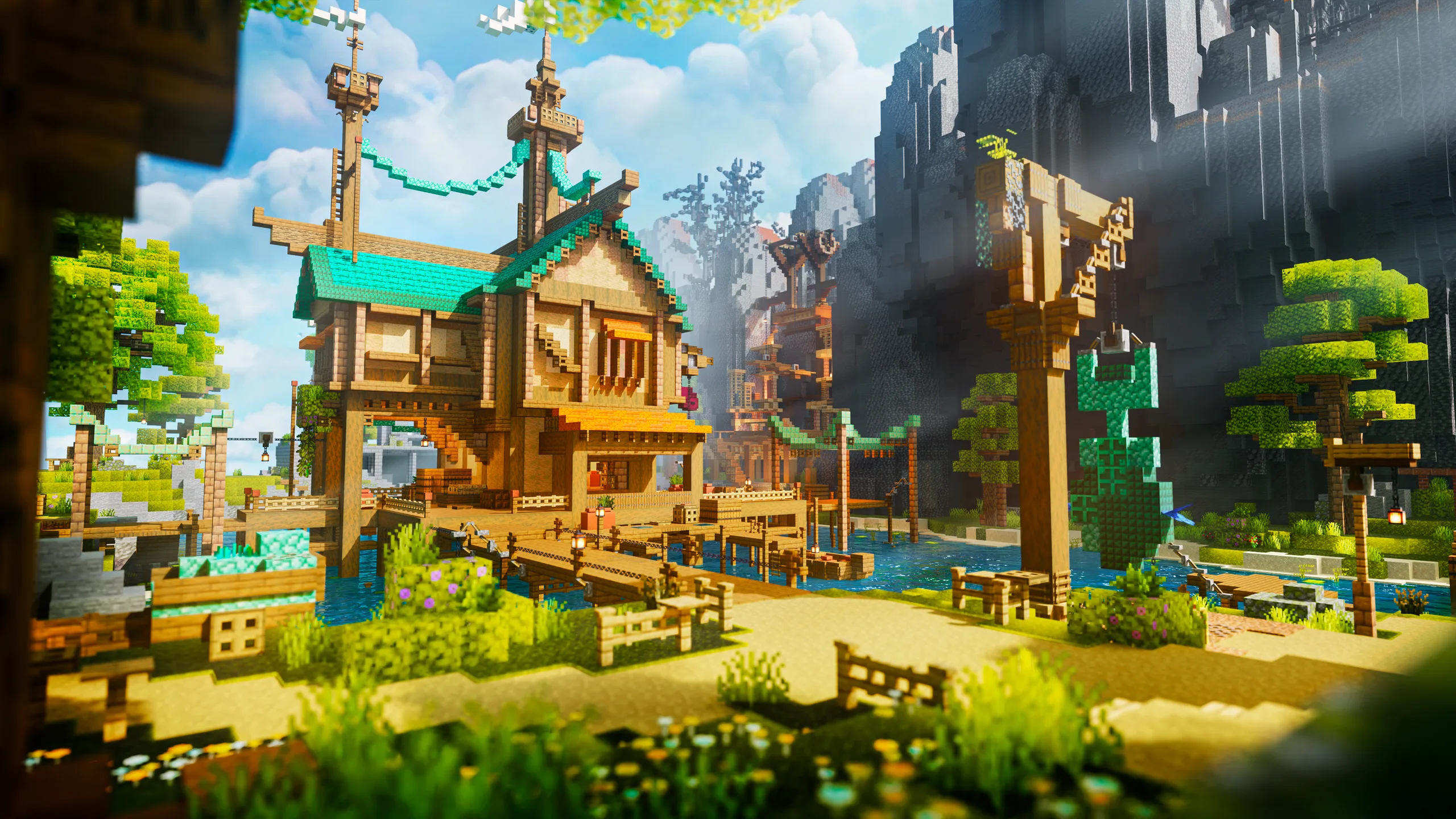 Minecraft scene of a wooden house with teal roofs beside a fenced dock and stream, set in a sunny valley with cliffs, trees, and warm tan and green terrain.