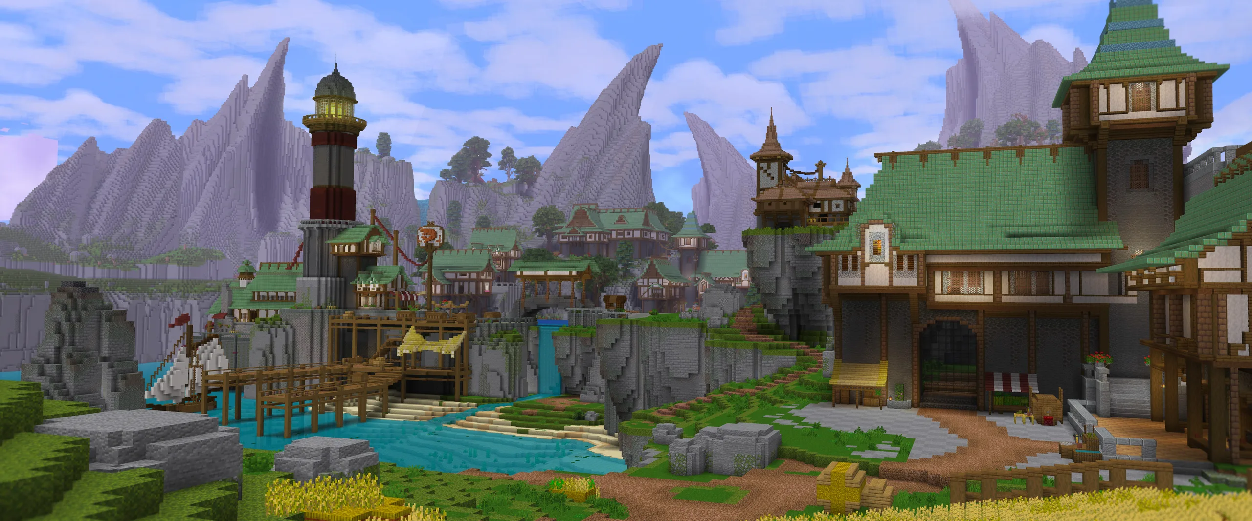 Minecraft harbor town on a cliff, with a green-roofed hall, tower, docks and bridges above bright blue water, framed by rocky mountains and cloudy sky.